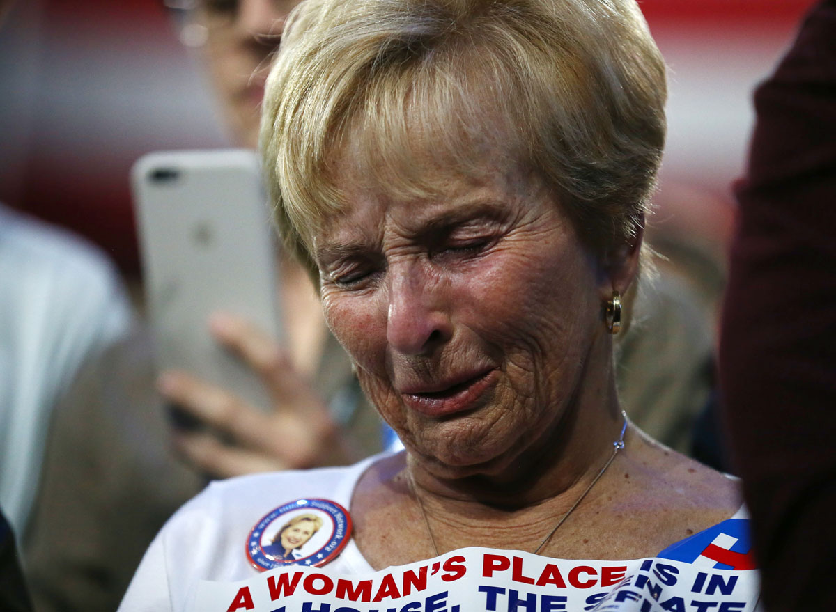 Supporter of Democratic presidential nominee Hillary Clinton watches and waits at her rally in New York