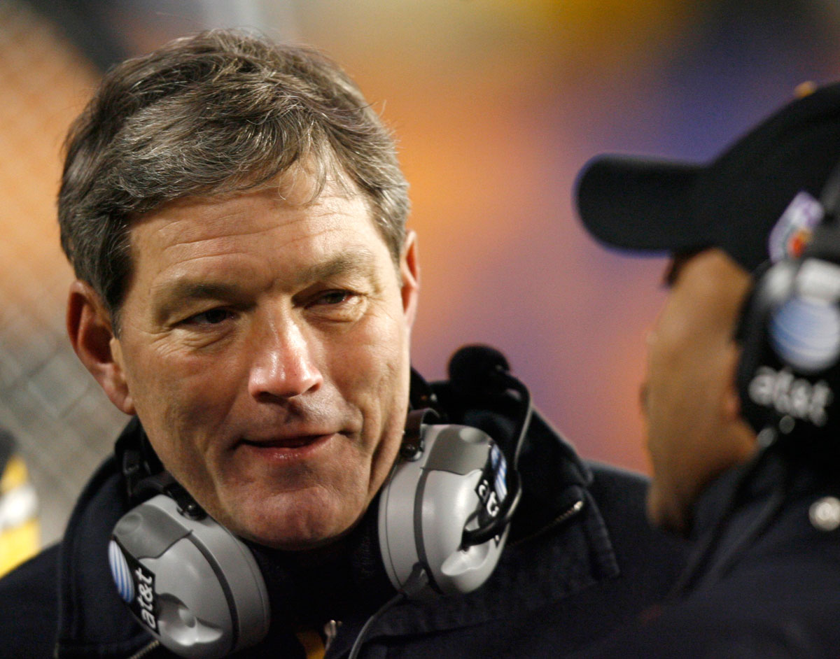 Iowa head coach Kirk Ferentz speaks with an assistant coach on the sidelines during his team's play against Georgia Tech in the FedEx Orange Bowl BCS NCAA football game in Miami