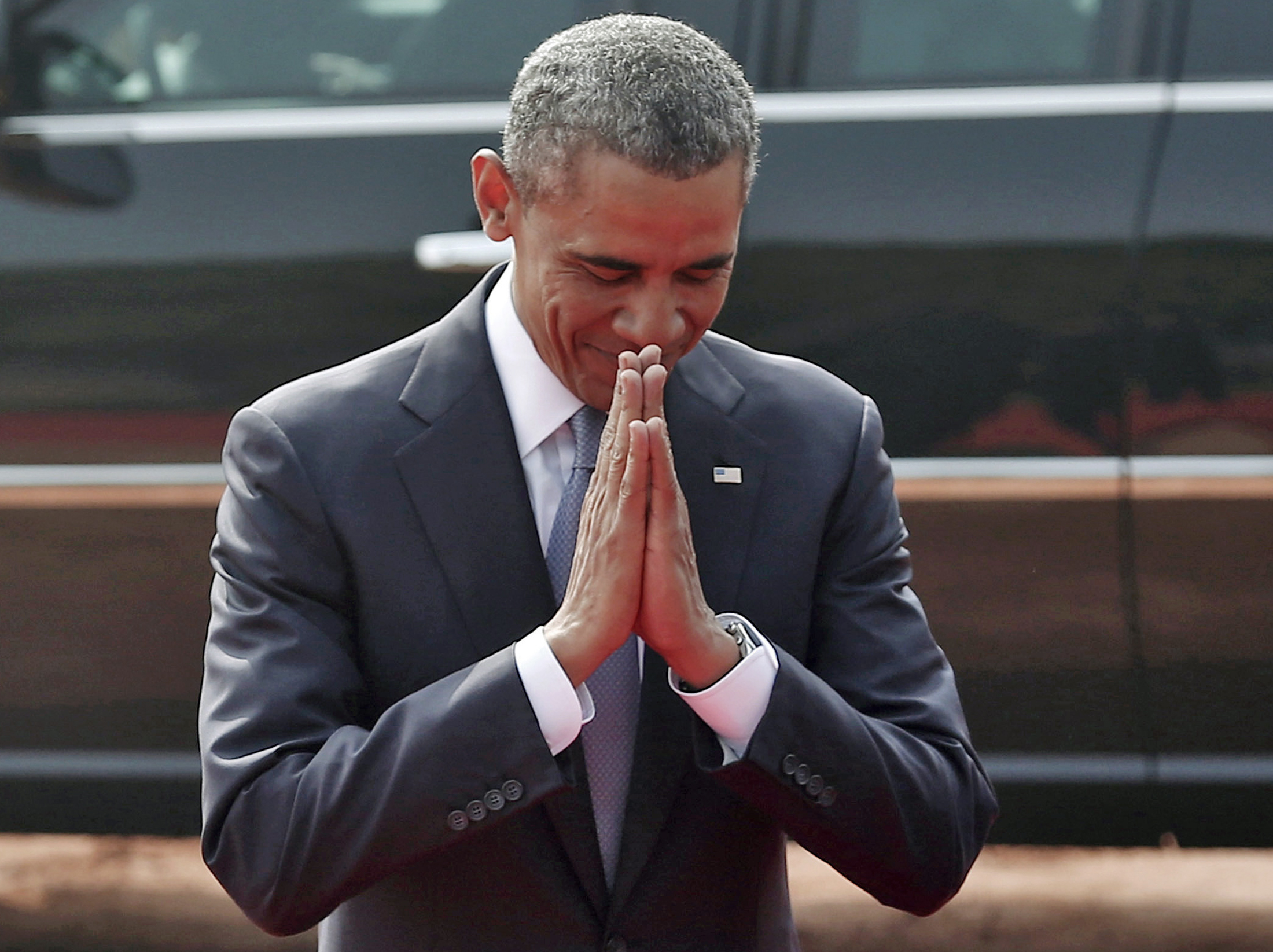 U.S. President Barack Obama folds his hands in a traditional Indian greeting before his ceremonial reception at the forecourt of India's presidential palace Rashtrapati Bhavan in New Delhi