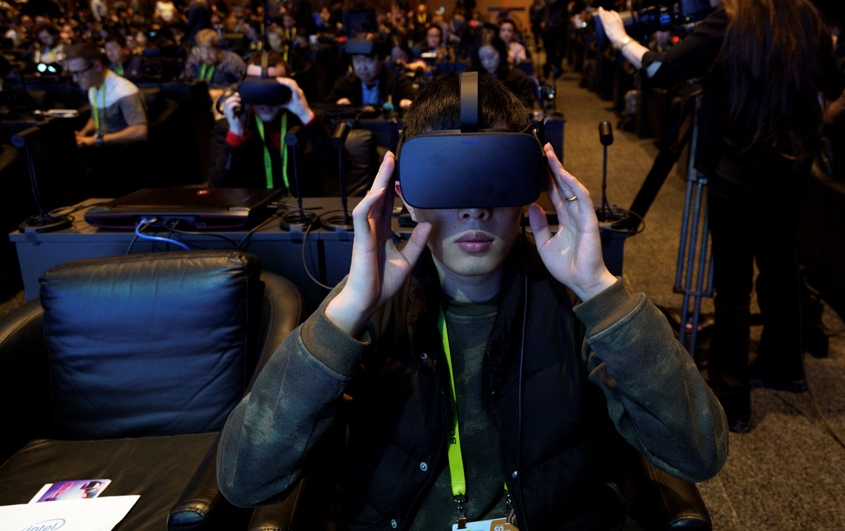 A showgoer wears an Oculus Rift vitual reality headset during the Intel press conference at CES in Las Vegas