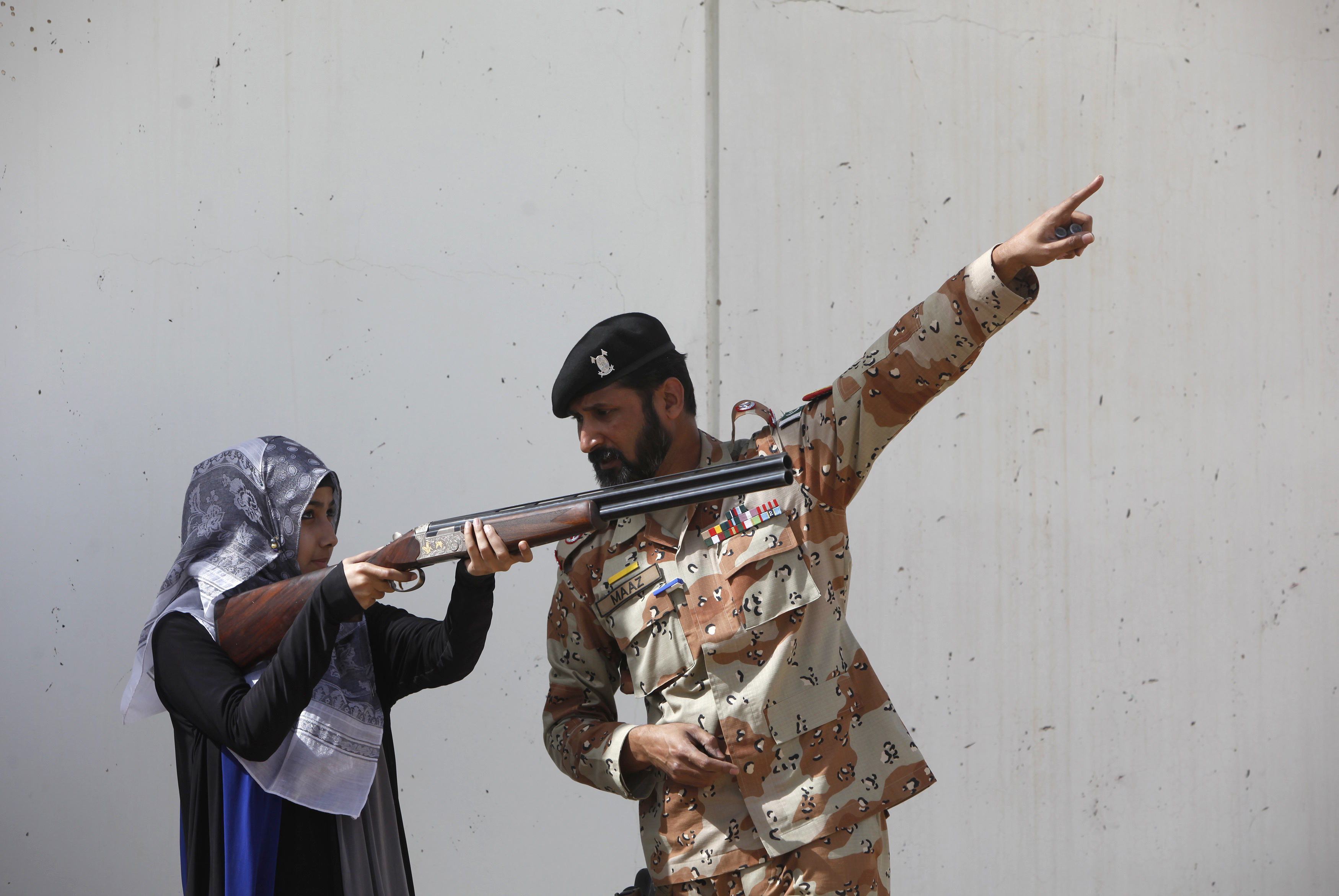 Pakistan Rangers soldier gestures as he instructs a female student of NED University during a counter-terrorism training demonstration at the RSSC on the outskirts of Karachi