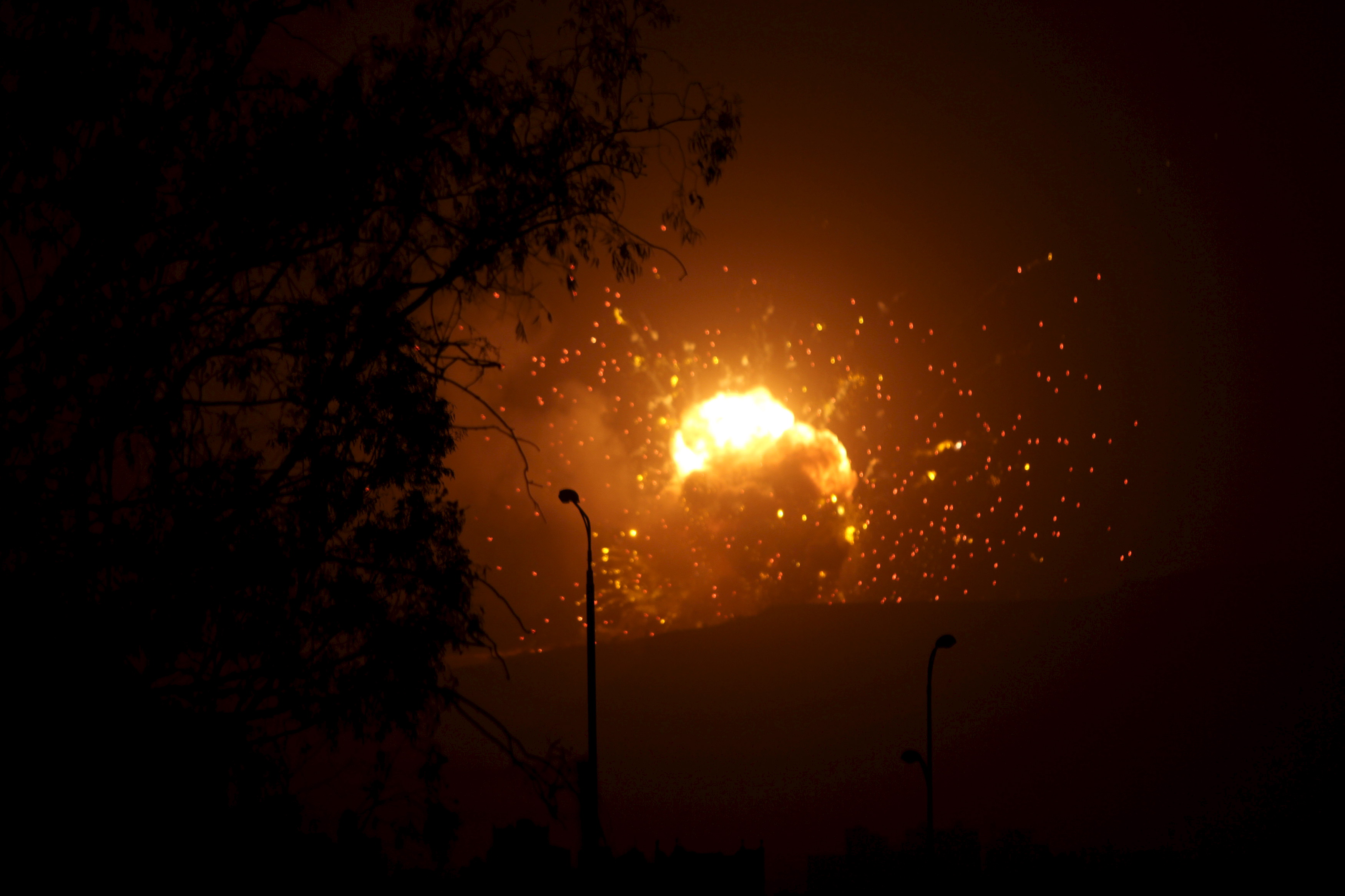 Fire is seen at a military site after it was hit by an air strike on the Faj Attan mountain of Sanaa