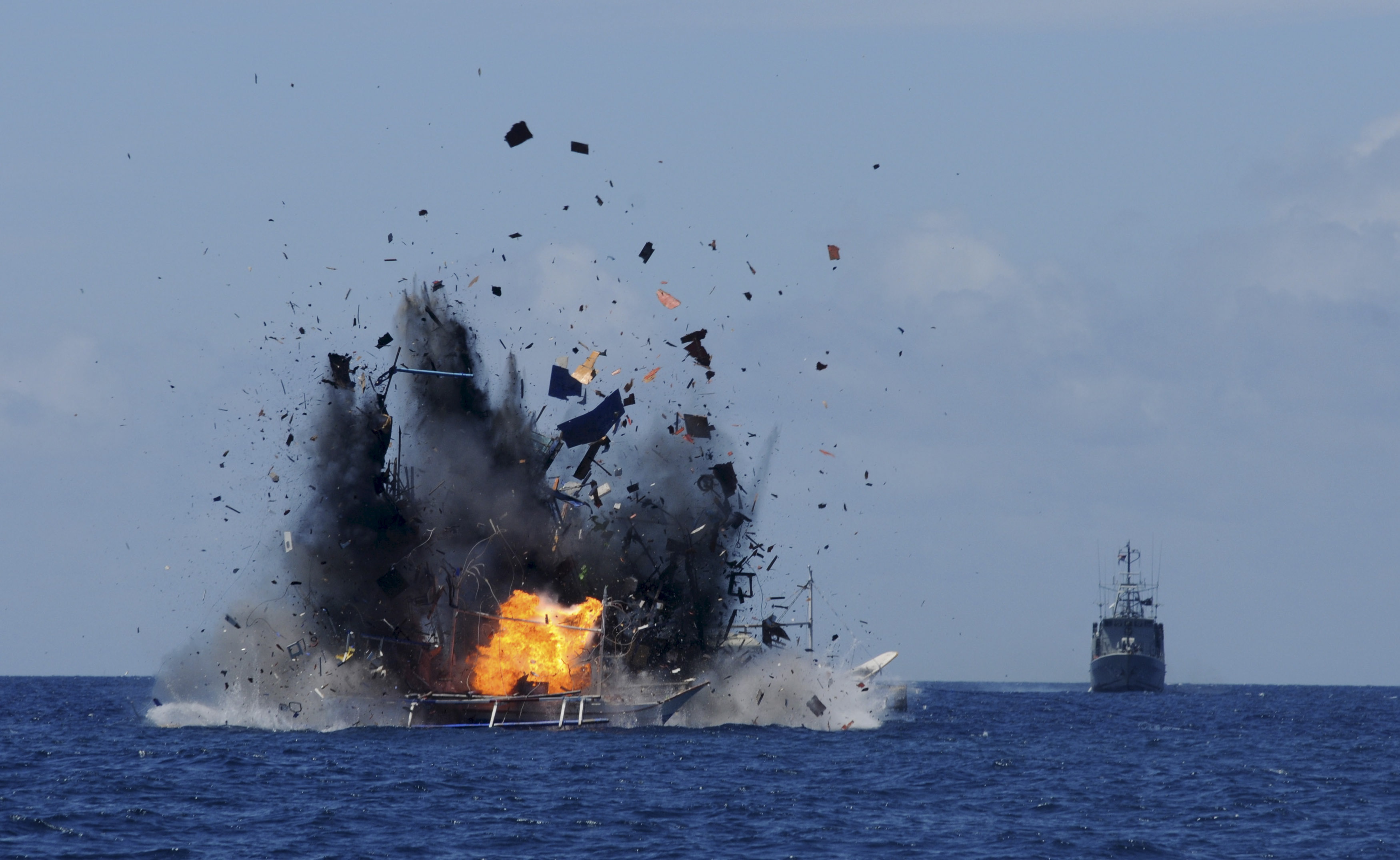 The Indonesian navy scuttles foreign fishing vessels caught fishing illegally in Indonesian waters near Bitung, North Sulawesi 