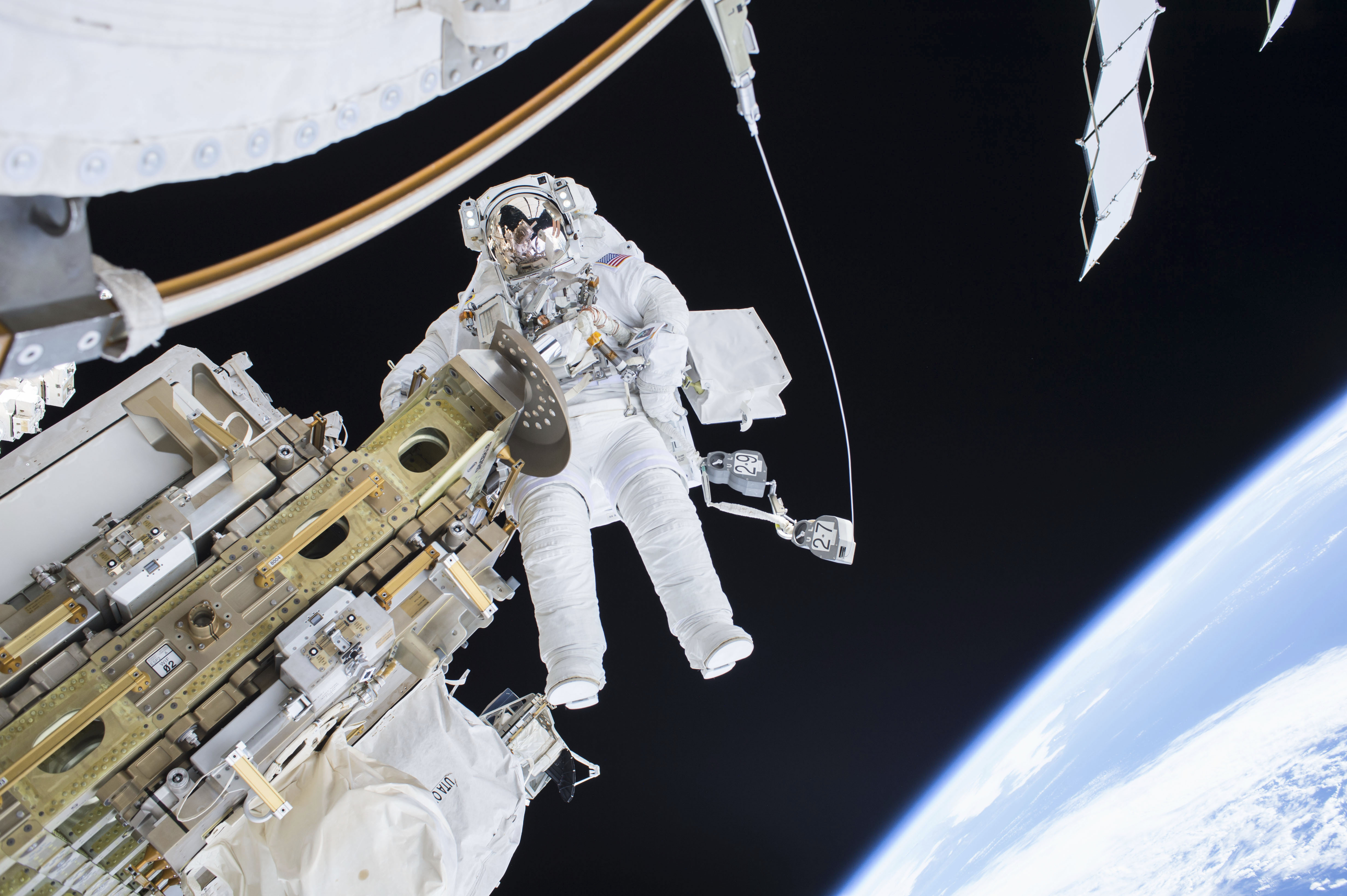 Expedition 46 Flight Engineer Tim Kopra performs a spacewalk outside the International Space Station in this NASA handout photo