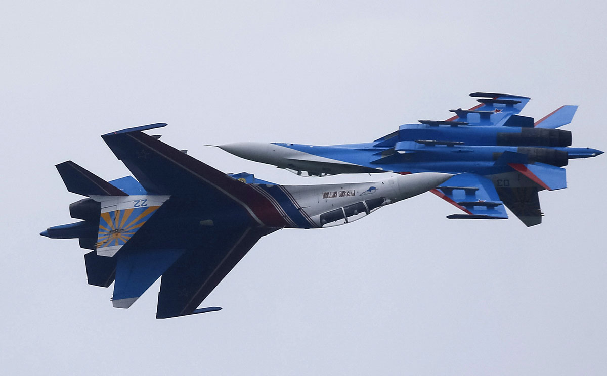 Sukhoi Su-27 Flanker fighters of Russian Knights aerobatic display team perform during demonstration flight at opening ceremony of International Army Games-2015 in Alabino