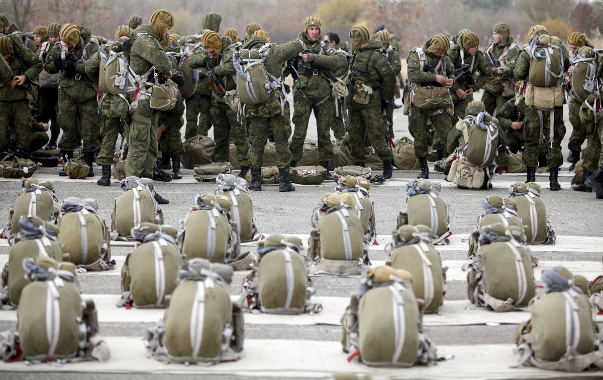 Conscripts, willing to join Russian airborne forces, get prepared before boarding a plane during parachute jumping military exercises outside the southern city of Stavropol