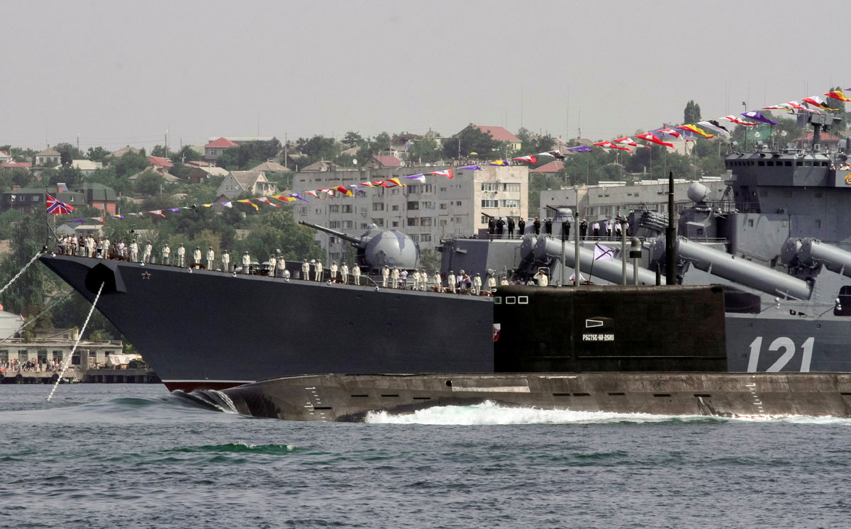 The Rostov-On-Don submarine sails past the guided missile cruiser Moskva during the Navy Day celebrations in Sevastopol, Crimea