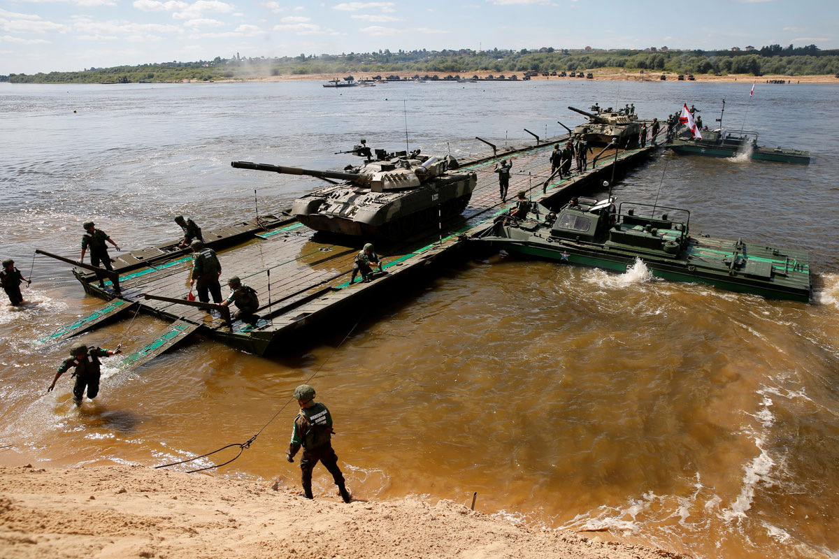 Russian crew members transport T-80 tanks on pontoon bridge during Open Water competition at International Army Games 2016 in Murom