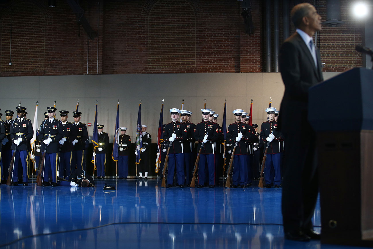 A member of the army lies on the floor after collapsing as U.S. President Barack Obama speaks during a military full honor review farewell ceremony given in his honor at Joint Base Myer-Henderson in Washington, U.S.