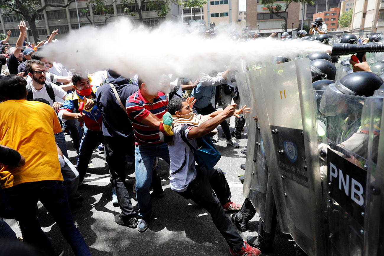 Demonstrators clash with security forces during an opposition rally in Caracas