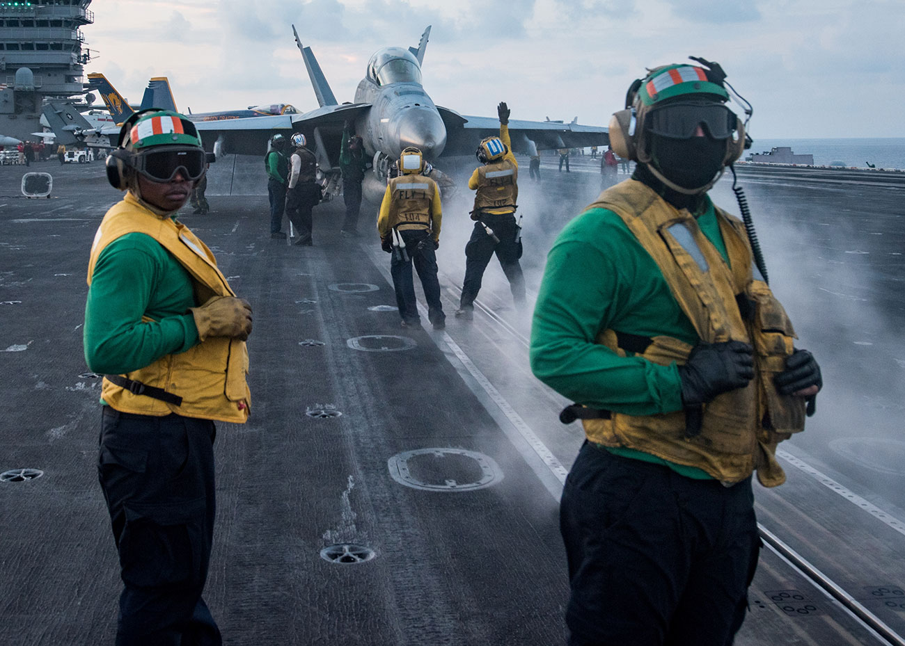 Sailors conduct flight operations on the aircraft carrier USS Carl Vinson flight deck, in the South China Sea