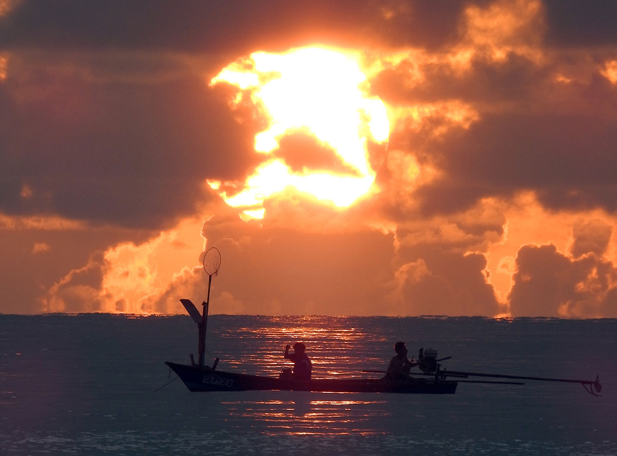 Fishermen anchor their boat at dawn off the coast of Koh Samui