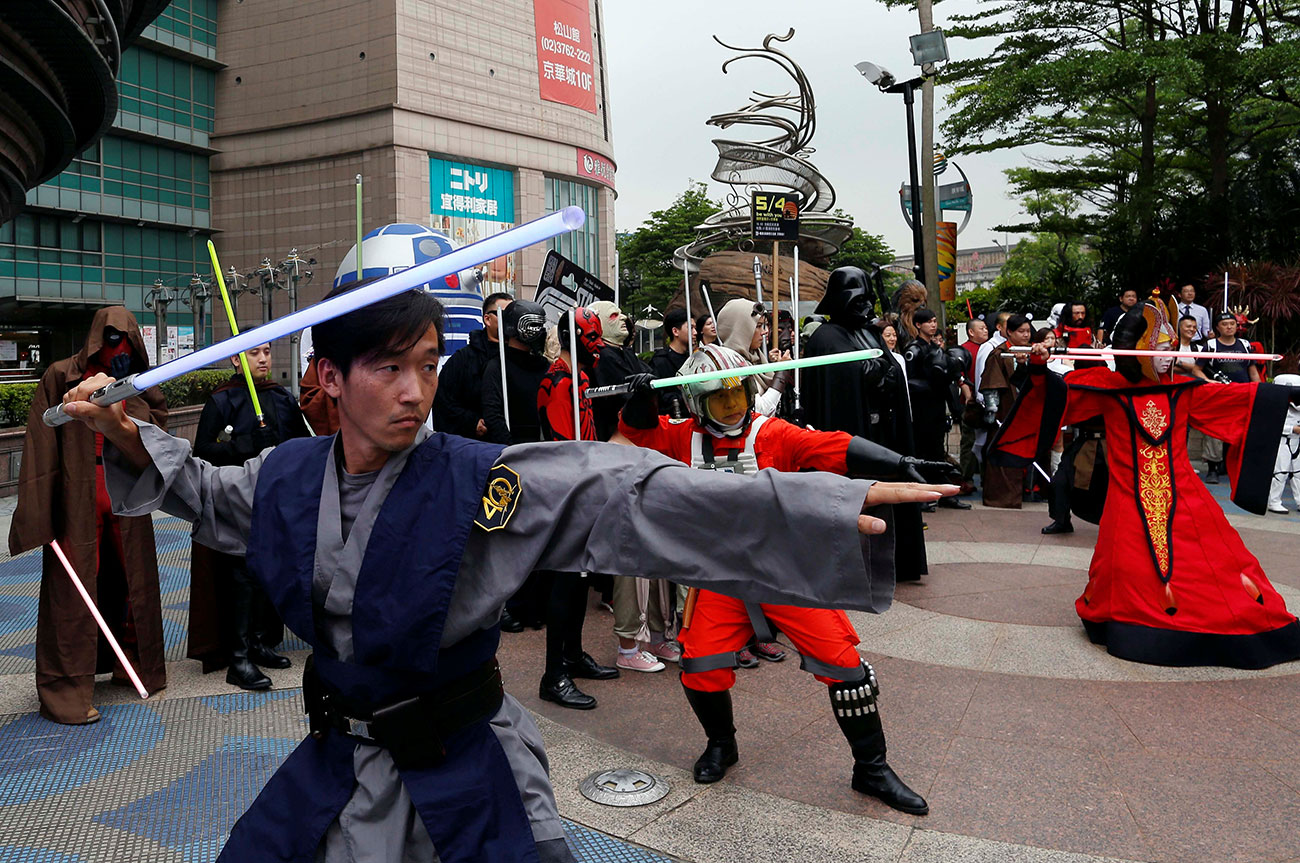 Fans dressed as the characters from "Star Wars" react during Star Wars Day in Taipei, Taiwan