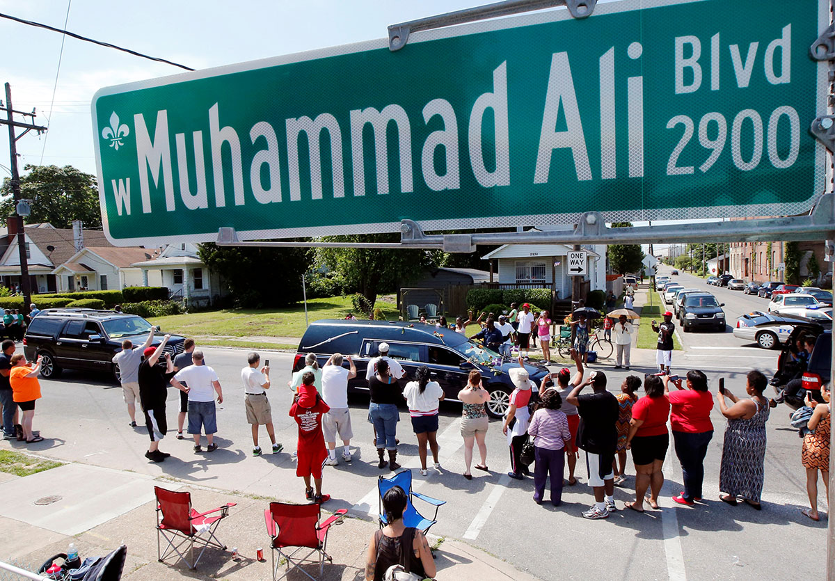 A hearse carrying the body of the late Muhammad Ali drives down Muhammad Ali Boulevard to Cave Hill Cemetery in Louisville