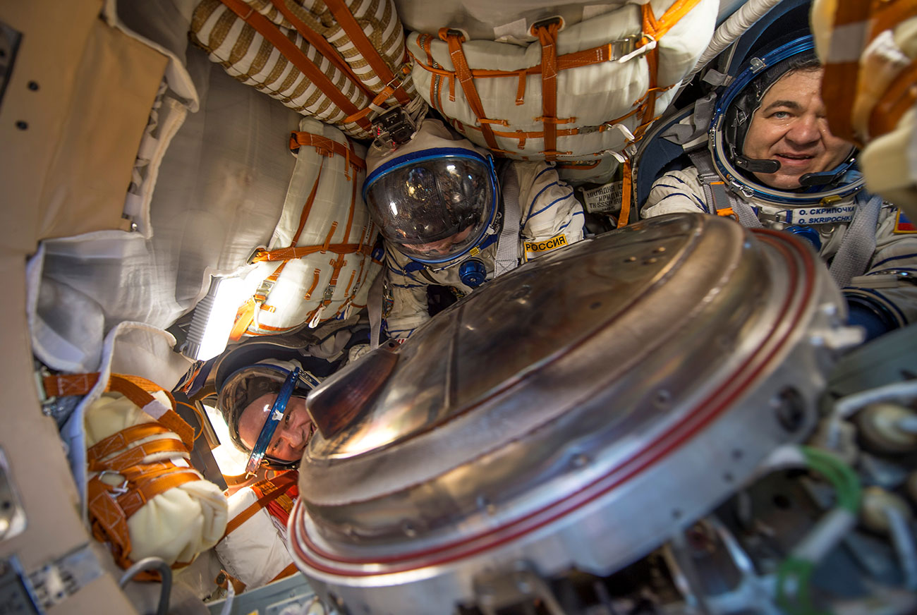 The International Space Station (ISS) crew members are seen inside the Soyuz TMA-20M spacecraft capsule after landing near the town of Zhezkazgan (Dzhezkazgan), Kazakhstan
