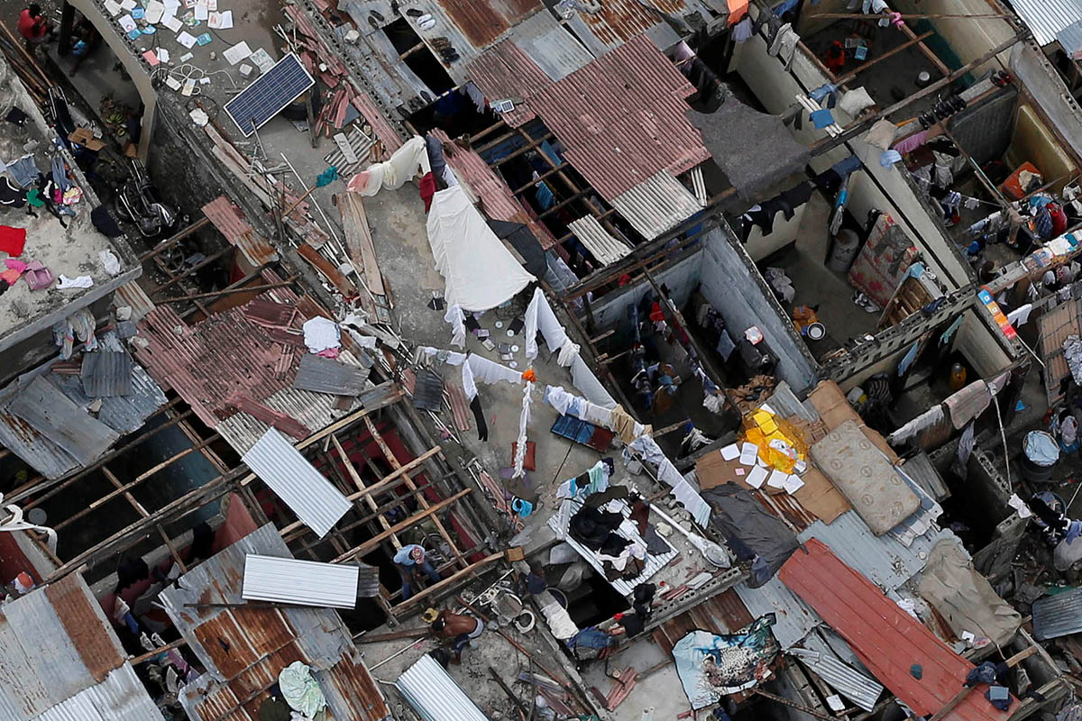 People try to rebuild their destroyed houses after Hurricane Matthew passes Jeremie