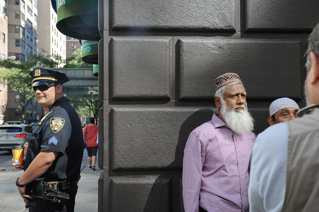 A member of the New York City police stands guard before the start of the annual Muslim Day Parade in the Manhattan borough of New York City