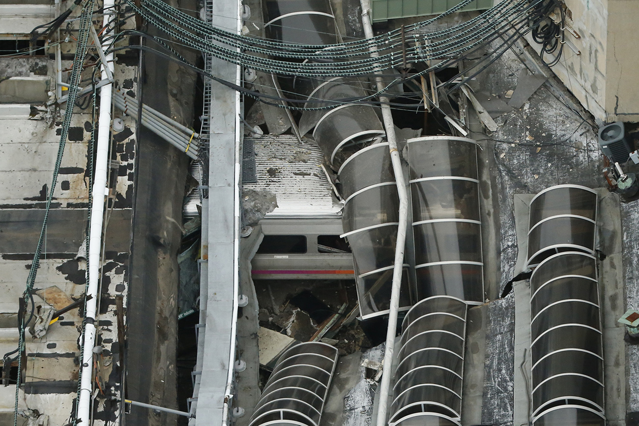 A derailed New Jersey Transit train is seen under a collapsed roof after it derailed and crashed into the station in Hoboken, New Jersey