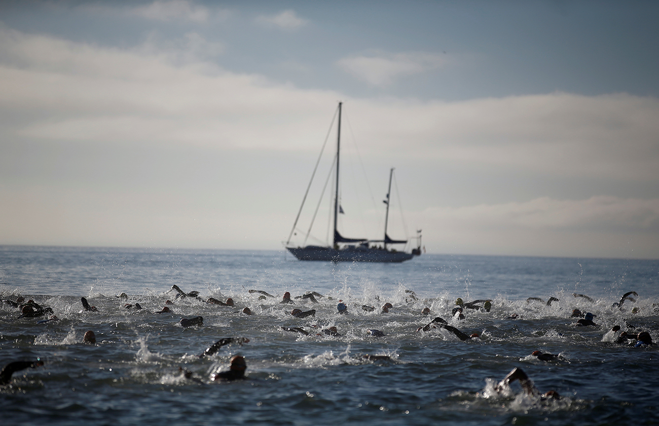 Participants swim in the Atlantic Ocean as they take part in a triathlon in Cascais