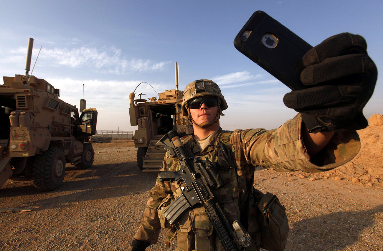 An American soldier takes a selfie at the U.S. army base in Qayyara, south of Mosul