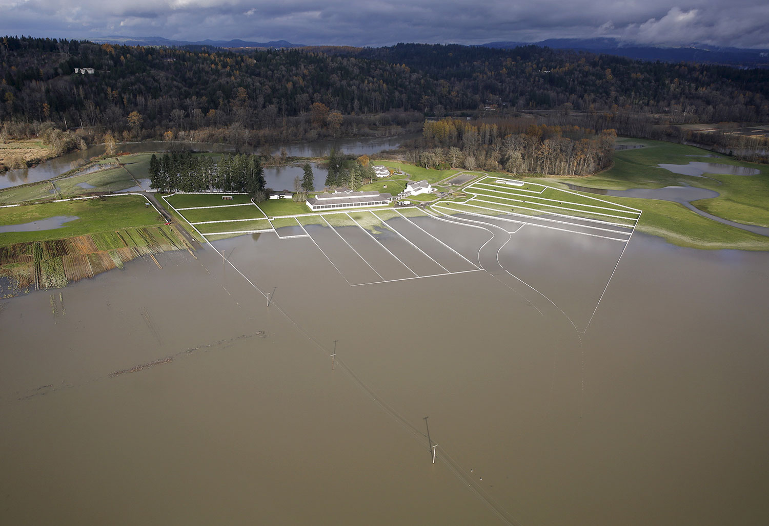 The flood waters of the Snoqualmie River cover 284th Ave NE in this aerial photo in Carnation, Washington