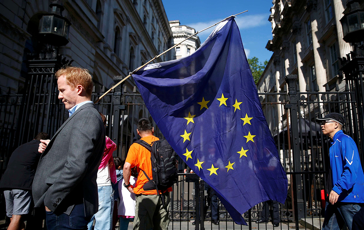 A man carries a EU flag, after Britain voted to leave the European Union, outside Downing Street in London