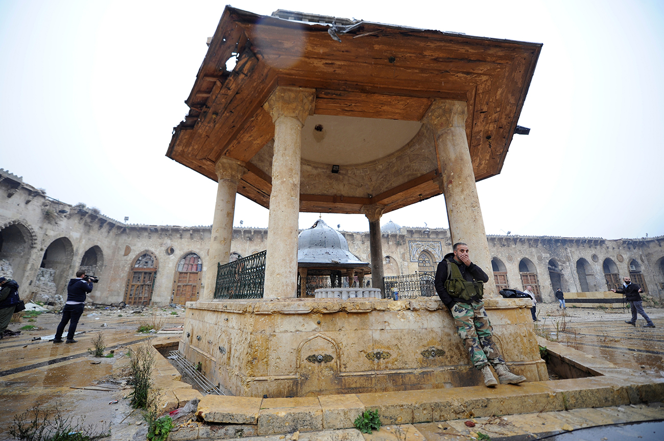 Forces loyal to Syria's President Bashar al-Assad stand inside the Umayyad mosque, in the government-controlled area of Aleppo