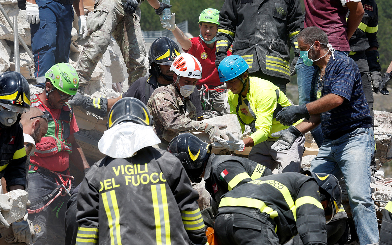 Rescuers work following an earthquake at Pescara del Tronto