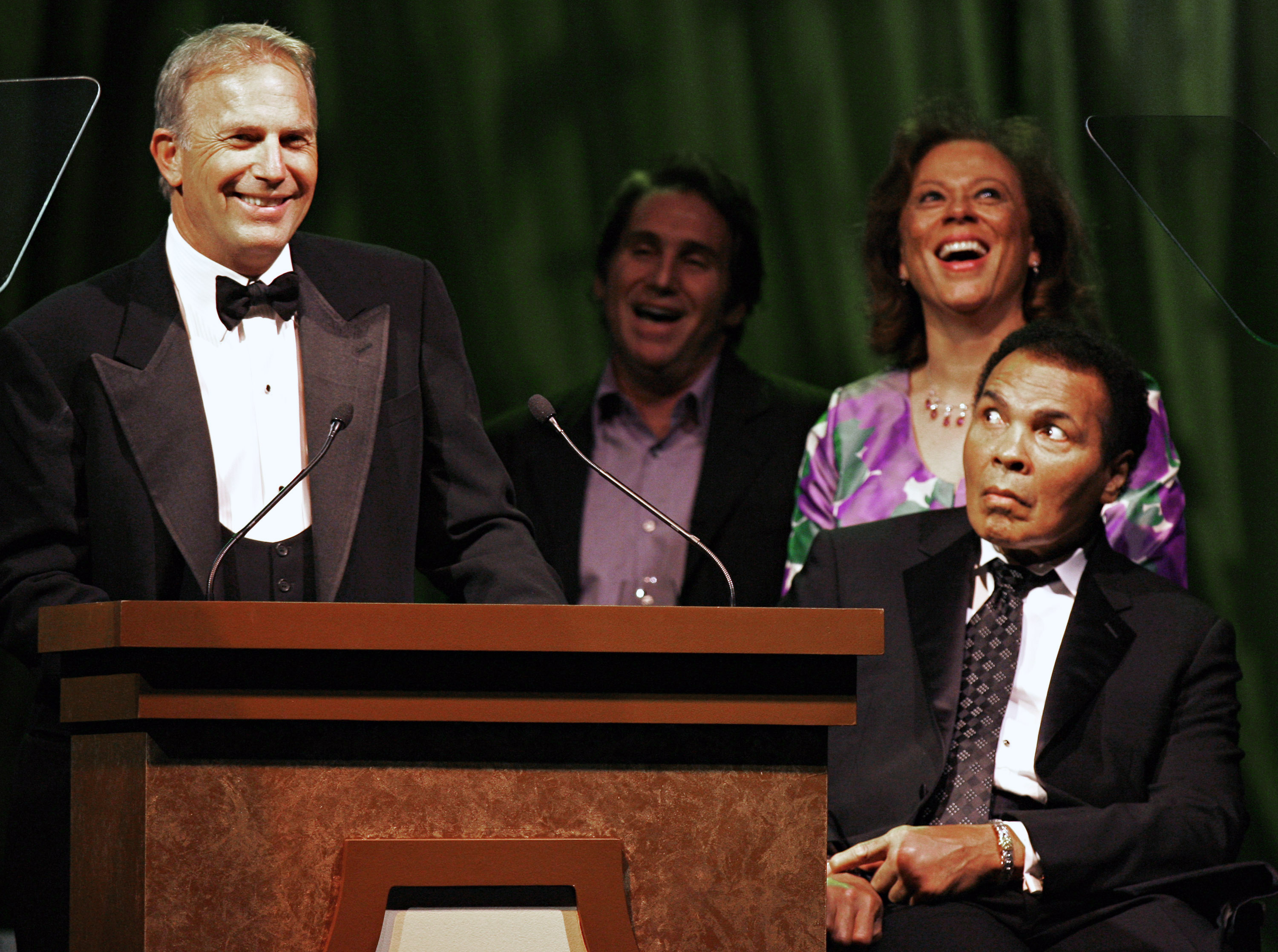 Muhammad Ali (R), along with his wife Lonnie and director Mike Binder react to a story told by actor Kevin Costner in Phoenix