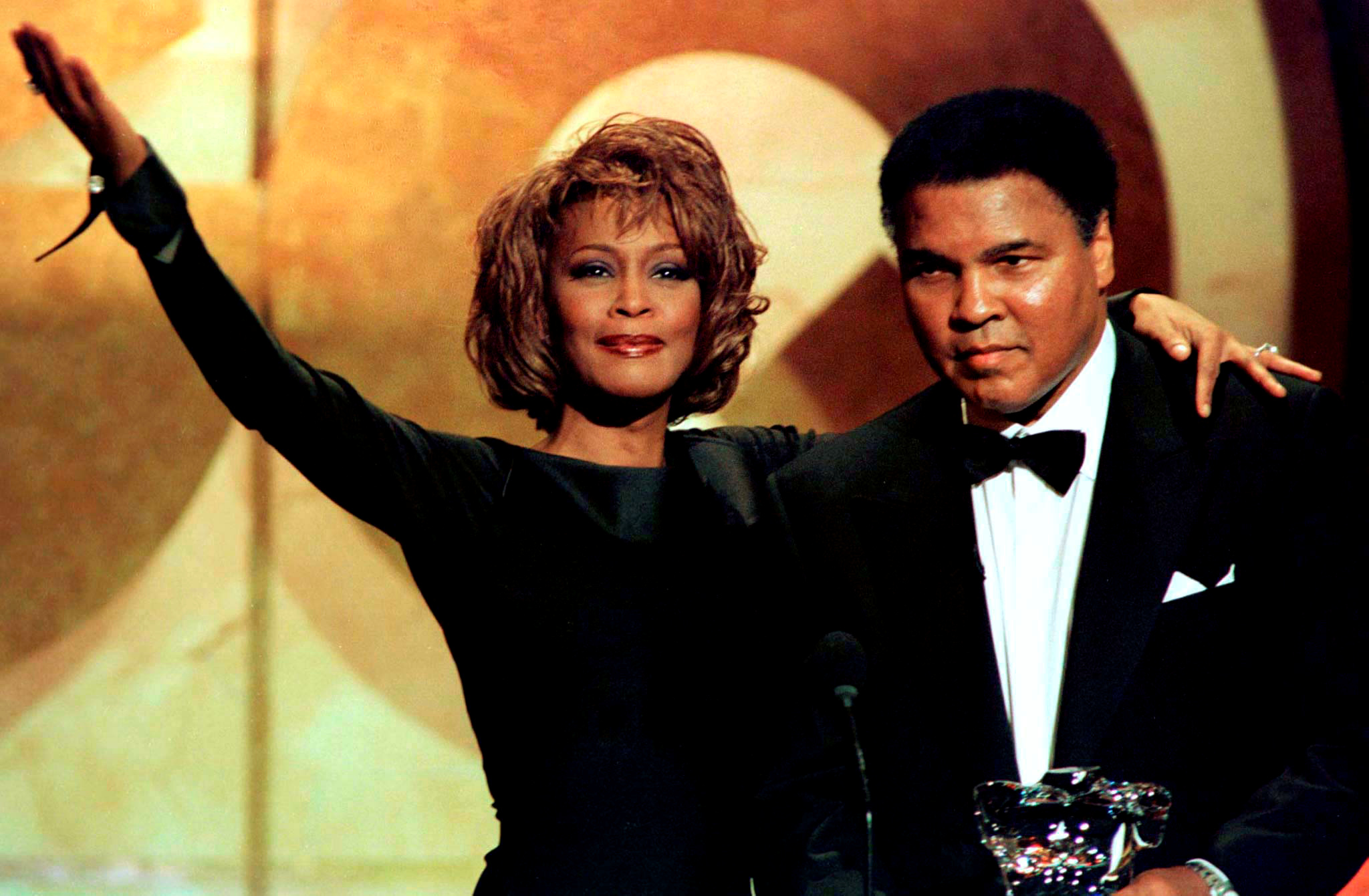 File photo of former boxing great Muhammad Ali as he is given the Courage Award by singer Whitney Houston at the GQ Men of the Year awards show in New York