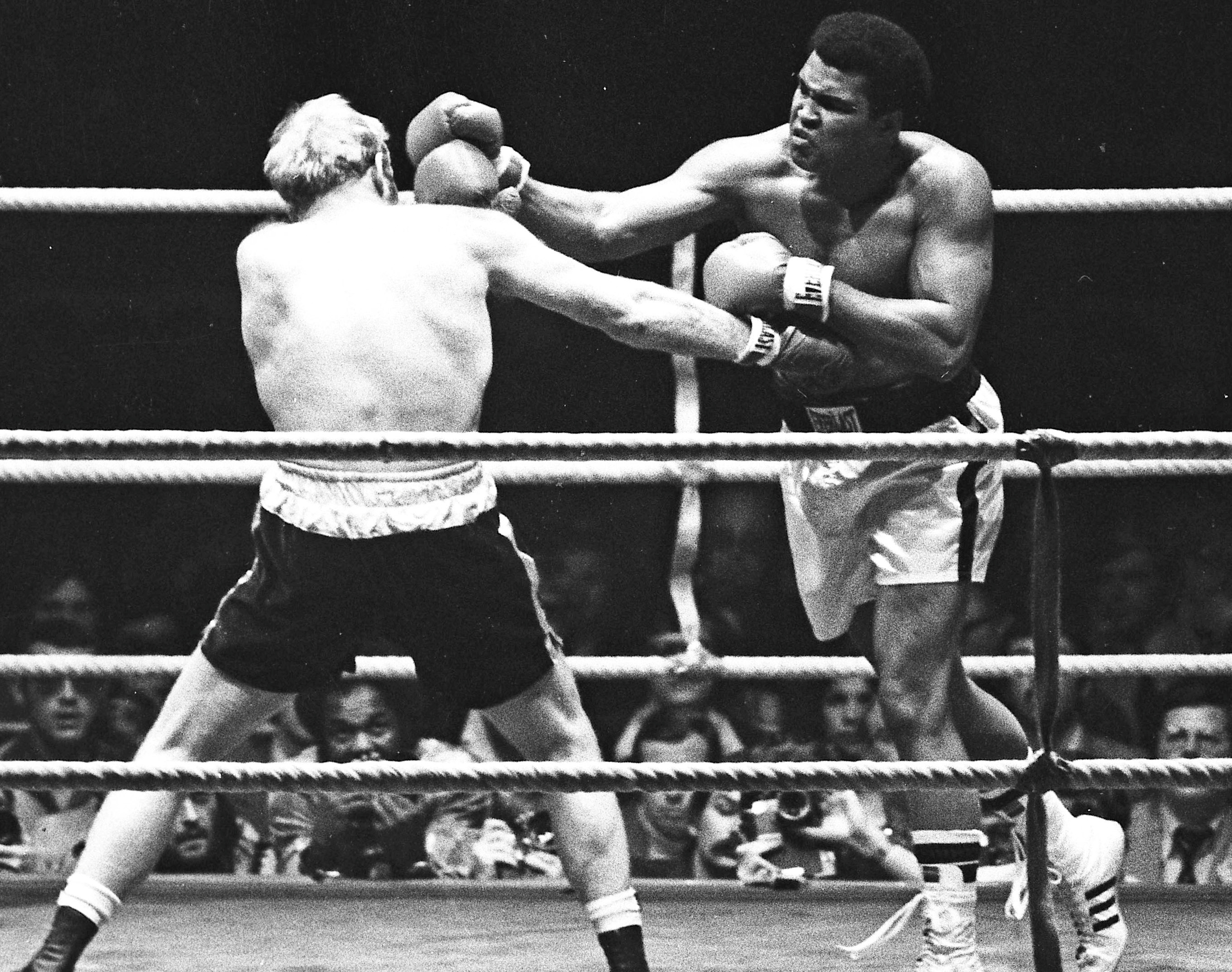 Muhammad Ali punches Richard Dunn while fighting for the WBC & WBA Heavyweight Title in Munich