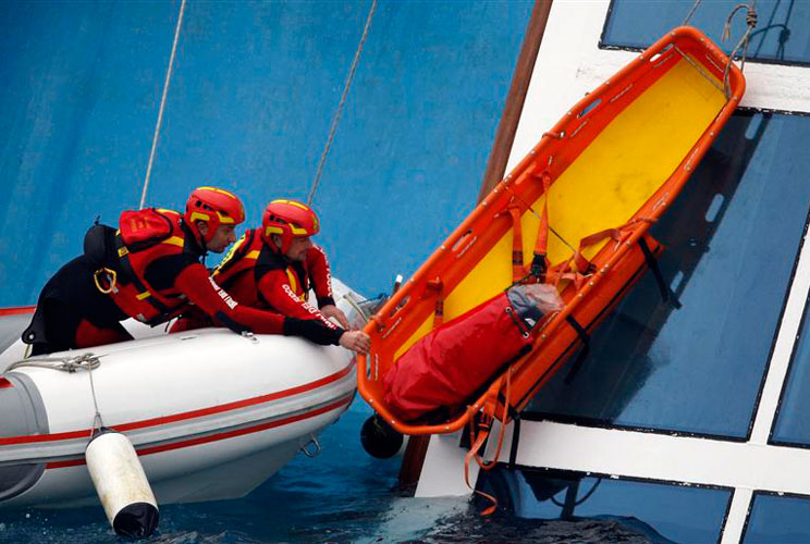 Rescue workers hold on to equipment next to the capsized Costa Concordia on January 16. 