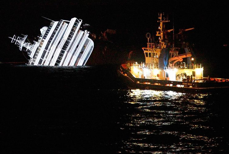 An oil removal ship is seen next to the Costa Concordia cruise ship as it ran aground off the west coast of Italy at Giglio island, January 16, 2012. Over-reliance on electronic navigation systems and a failure of judgement by the captain are seen as poss