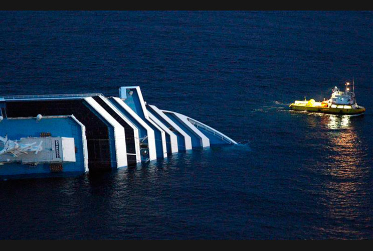 Rescue workers inspect the side of the Costa Concordia cruise ship. Salvage work was reportedly due to begin Wednesday, Jan. 18.