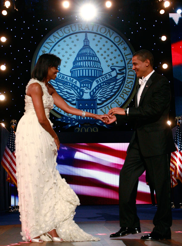 		<p>First Lady Michelle Obama pulls up the train of her dress as she dances her first dance of inauguration night with President Barack Obama during the Neighborhood Inaugural ball in Washington, January 20, 2009. Barack Obama took power as the first bla