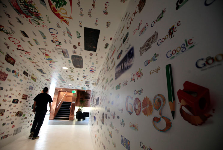 A man walks through a tunnel of Google homepage logos at the Google campus near Venice Beach, in Los Angeles, California January 13, 2012. The 100,000 square-foot campus has around 500 employees who develop video advertising for YouTube, parts of the Goog