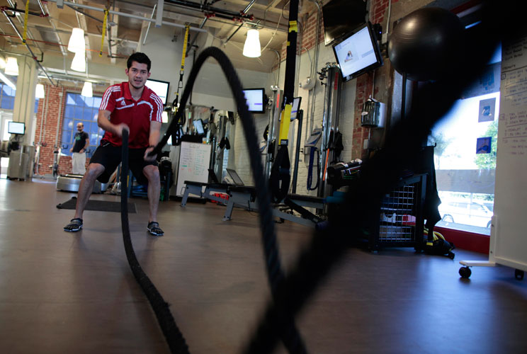 Performance specialist David Delgado, 27, demonstrates a rope exercise in the company gym which is open 24 hours a day. 