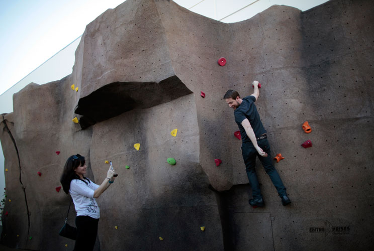 Systems Integrator Robert Scott, 32, (R) is photographed by his girlfriend Abby Pynes, 33, as he tries out the rock climbing wall.