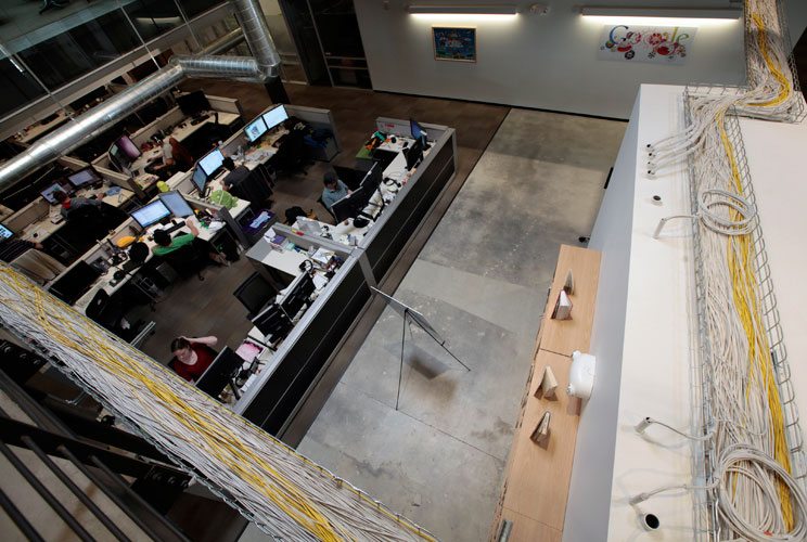 Data cables are seen above the main office floor.