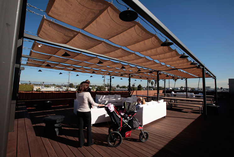 Women sit on the roof deck.