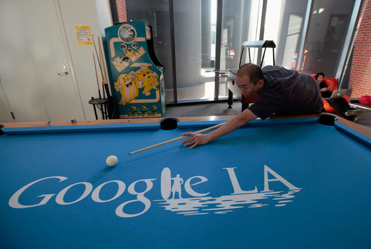 An employee plays pool.