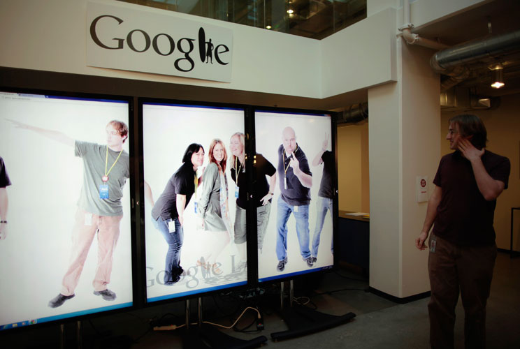 Software Engineer for Google+ mobile photos Ken Arthur, 27, views a scrolling employee photo collage that he helped develop in the 20% of his work time which Google employees can devote to personal projects.