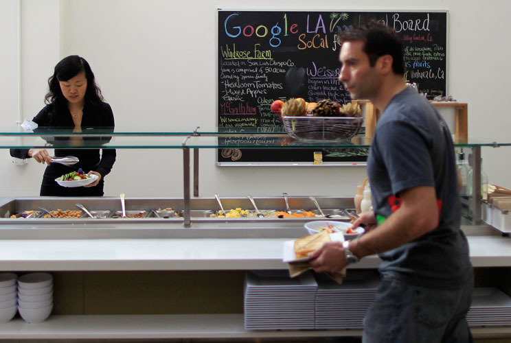 People eat in the cafeteria.   