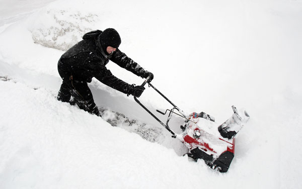 		<p>Shawn Shattuck uses a snowblower to clear a sidewalk after more than twelve inches of snow fell in Minneapolis, February 21, 2011.</p>