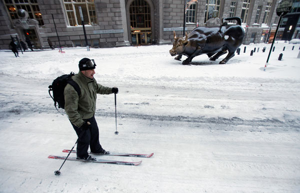 		<p>A man skis past a bronze statue of a charging bull on Wall St. after a snow storm in New York December 27, 2010. A blizzard pummeled the northeastern United States on Monday, dumping up to 29 inches (74 cm) of snow, disrupting air and rail travel and