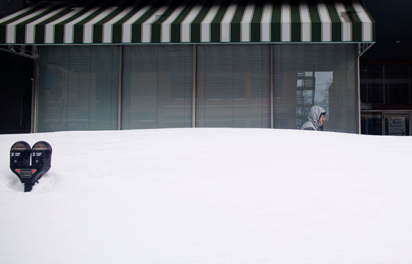 		<p>A man walks behind high snowdrift in Racine County, Wisconsin February 2, 2011. A colossal winter storm stretching from New Mexico to Maine hit the heartland of the United States with snow, high winds and freezing rain on Tuesday, and experts said th