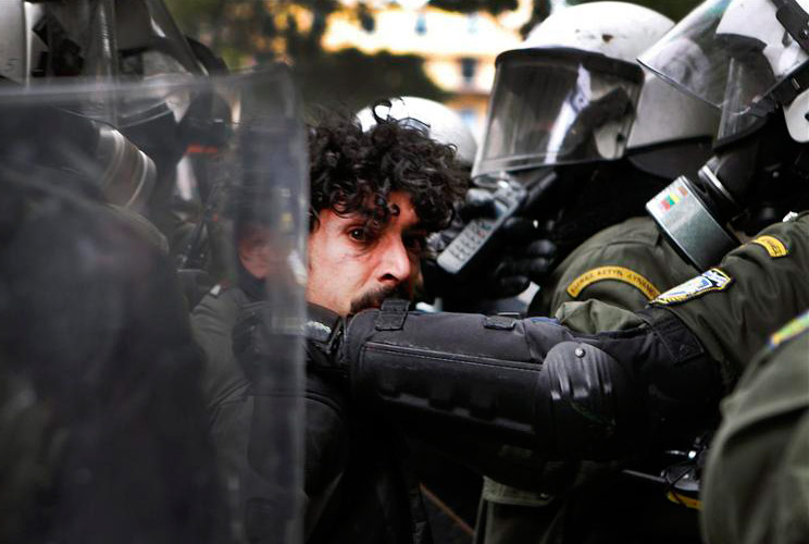 A demonstrator is detained by riot police during protests in Athens's Syntagma (Constitution) square against planned reforms by Greece's coalition government, February 10, 2012.