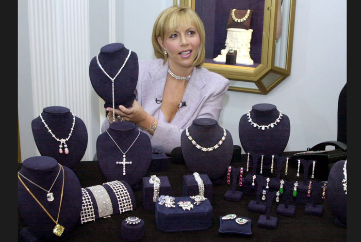 Carol Brodie, a spokesperson for the House of Harry Winston, holds up a Y-shaped necklace set with round and pear-shaped diamonds, part of $73 million in jewels displayed at the House of Harry Winston in Beverly Hills. Many of the jewels will be worn by n