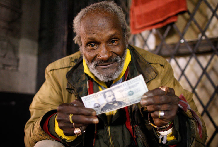 Richard McFarthing, a homeless man who sleeps on Hollywood Boulevard, shows off his play money. 