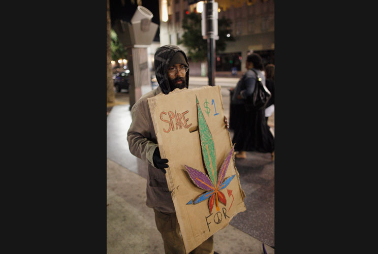 Clarence Witzel, a homeless man, begs for money to buy marijuana on Hollywood Boulevard.